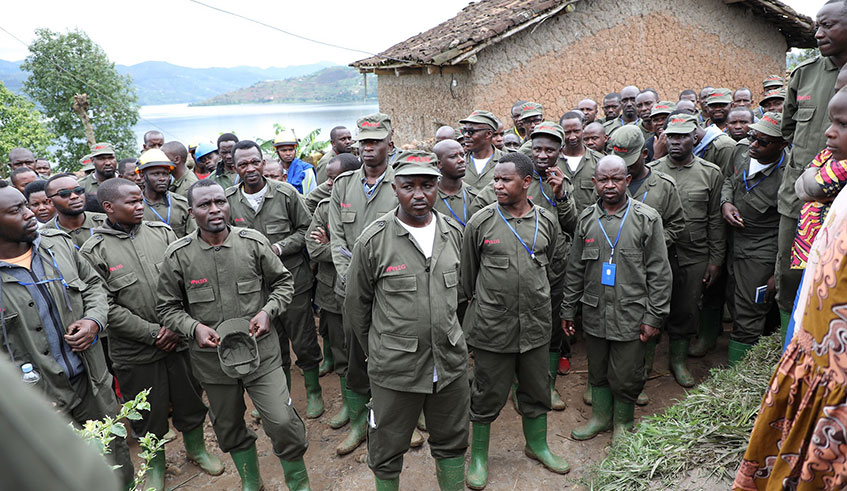 A team of technicians who connected Nkumba Cell with electricity pose at a house of one the beneficiaries. Photo: Courtesy.