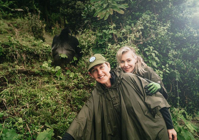Ellen DeGeneres and her partner Portia de Rossi pose besides a mountain gorilla in Volcanoes National Park during their visit to Rwanda in May 2018. (Courtesy) 