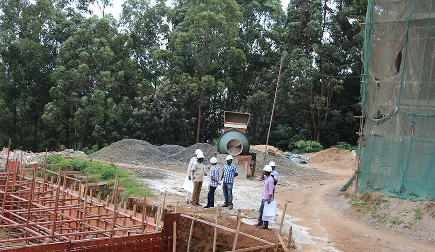 Engineers discuss work progress at a construction site in Rusizi District. Photo: File.