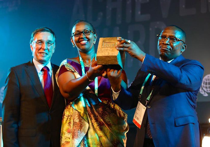 Amb. Amandin Rugira, Rwandau2019s envoy to Belgium (right), and Dr Solange Hakiba, the deputy director-general of Rwanda Social Security Board, lifts the award trophy at the World Social Security Forum in Brussels, Belgium earlier on Friday. Courtesy.
