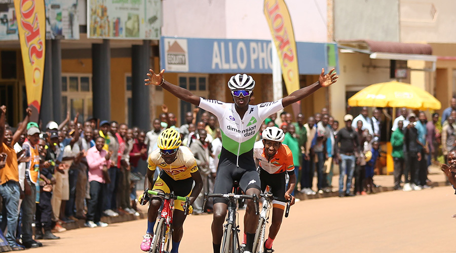 Samuel Mugisha throws his arms in the air to celebrate his victory after crossing the finish-line in Huye District on Saturday afternoon. / Sam Ngendahimana