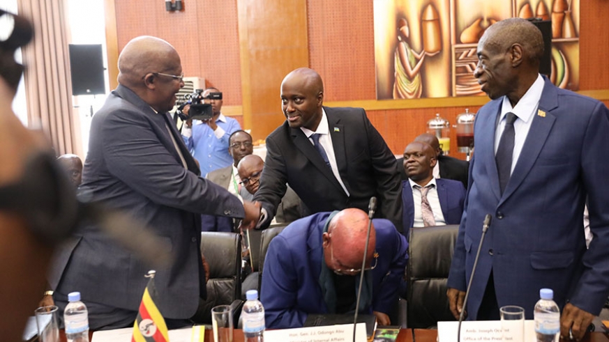 State Minister for Foreign Affairs, Amb. Olivier Nduhungirehe welcomes Uganda's Foreign Minister, Sam Kutesa (L) to the meeting during the first meeting in Kigali last month. (Emmanuel Kwizera)
