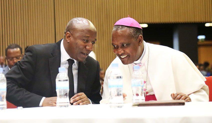 Prime Minister Edouard Ngirente consults with Archbishop Antoine Kambanda, the legal representative of the Bible Society of Rwanda, at the African Biblical Leadership Initiative (ABLI) Forum in Kigali yesterday. Sam Ngendahimana.