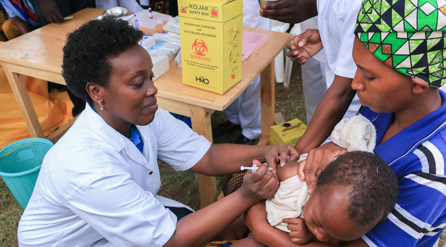 Health minister Dr Diane Gashumba vaccinates a child. / File