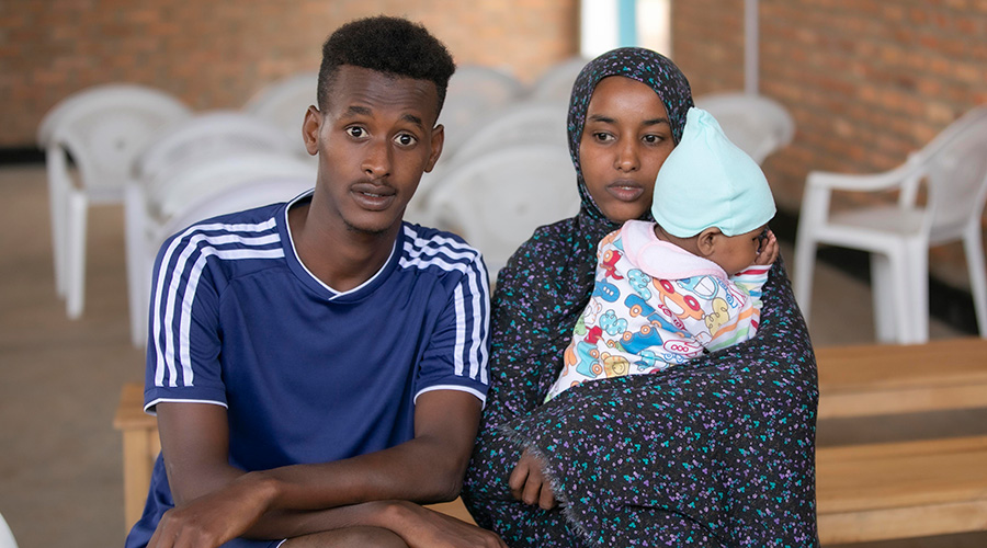 Ismael Abdibasid and his partner Yusuf Hussein Zeinab with their child at the Gashora Transit Centre in Bugesera District. / Emmanuel Kwizera 