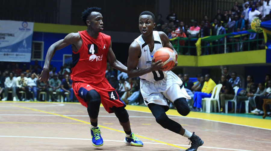 Guibert Nijimbere (R) is seen here dribbling past Wilson Nshobozwabyosenumukiza (who is part of Team Aristide) during a past game at Amahoro Stadium in June. / File