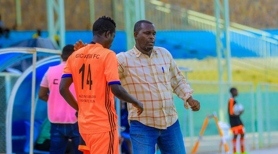 Jean-Marie Vianney Nduwantare talks to a player during a past league match at Kigali Stadium. / Courtesy