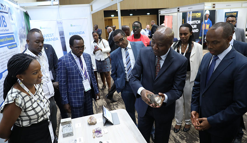 Prime Minister Edouard Ngirente and other officials tour in a mini-exhibition on the opening day of the East and Central African Mining Forum in Kigali yesterday. The Government has called on investors to put Lithium extraction and processing top of the agenda.. Emmanuel Kwizera. 