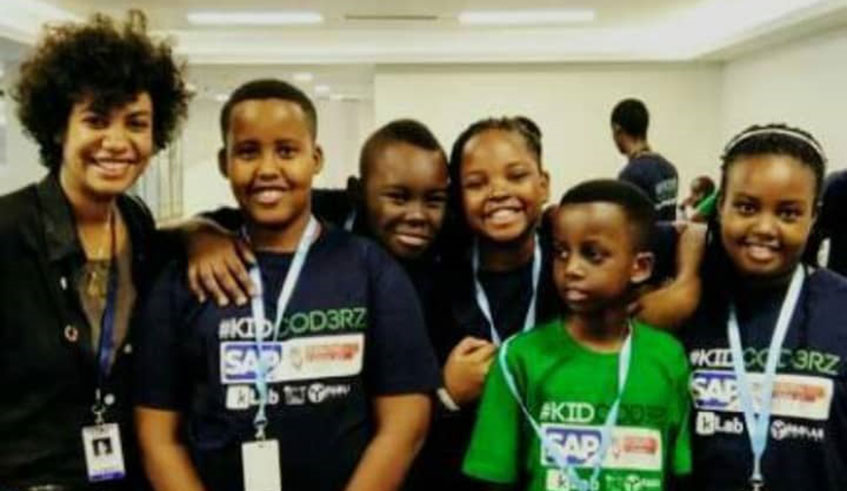 Nziza (second left) poses for a group photo with his team after attending the Youth Connekt coder. Courtesy photos.