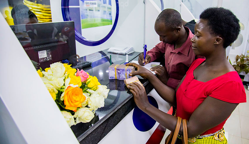 Customers being served in a banking hall in Kigali. File.