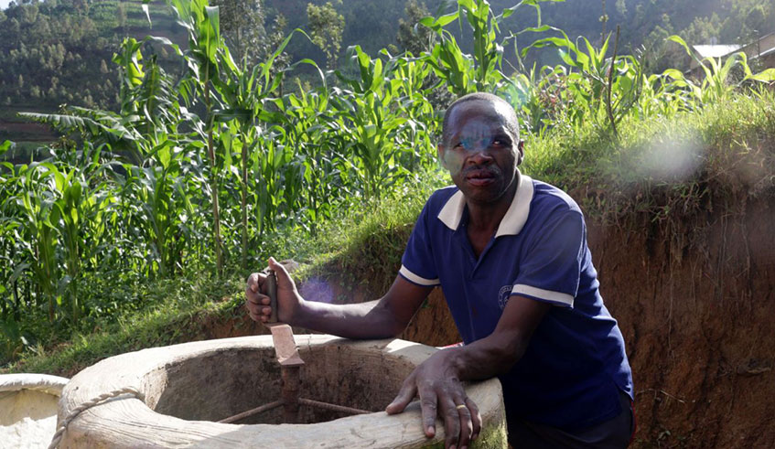 Etiene Twagirayezu, 60, talks about his biogas digester in front of his home in Rutabo, Ruhango District. Courtesy.