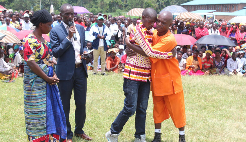 A survivor and a convicted perpetrator hug during a past reconciliation meeting in Rubavu District earlier this year. Photo: File.