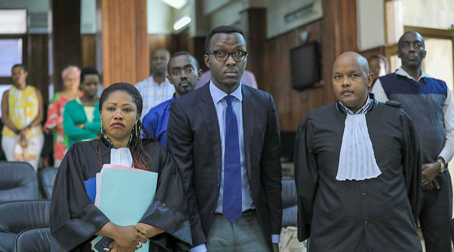 Yves Tuyishimire (centre) with his lawyers during the hearing at the Supreme Court in Kigali on November 7, 2019. / Emmanuel Kwizera