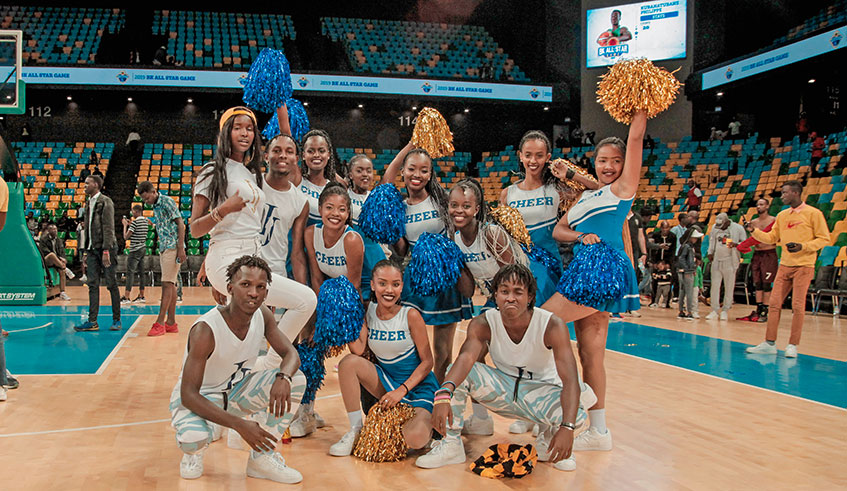 Kabagire (L) with the girls after performing at a game