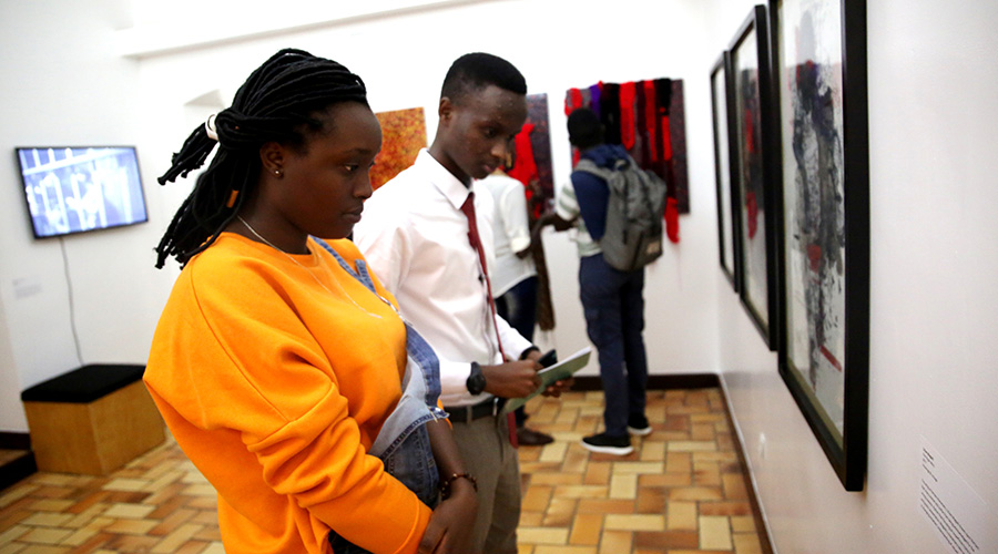 Participants look at some of the works during the launch of the exhibition. / Craish Bahizi