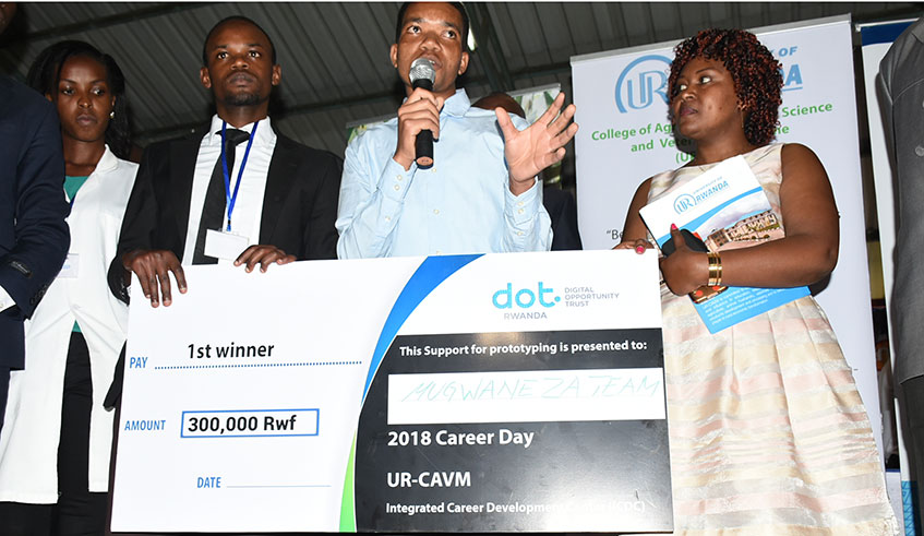 Mugwaneza (2nd left) with a dummy cheque for the cash prize he won after his sweet potato processing project was selected the best in a university competition last year. / Courtesy photos