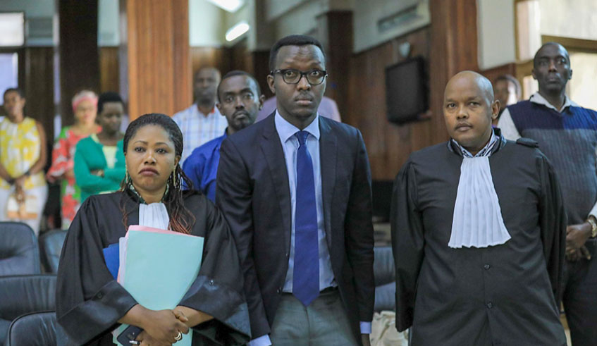 Yves Tuyishimire (centre) with his lawyers during the hearing at the Supreme Court in Kigali on November 7, 2019. File.