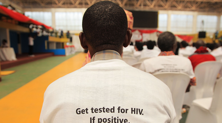 A participant puts in a T-shirt with the message that calls up on people to get tested for HIV. / Sam Ngendahimana