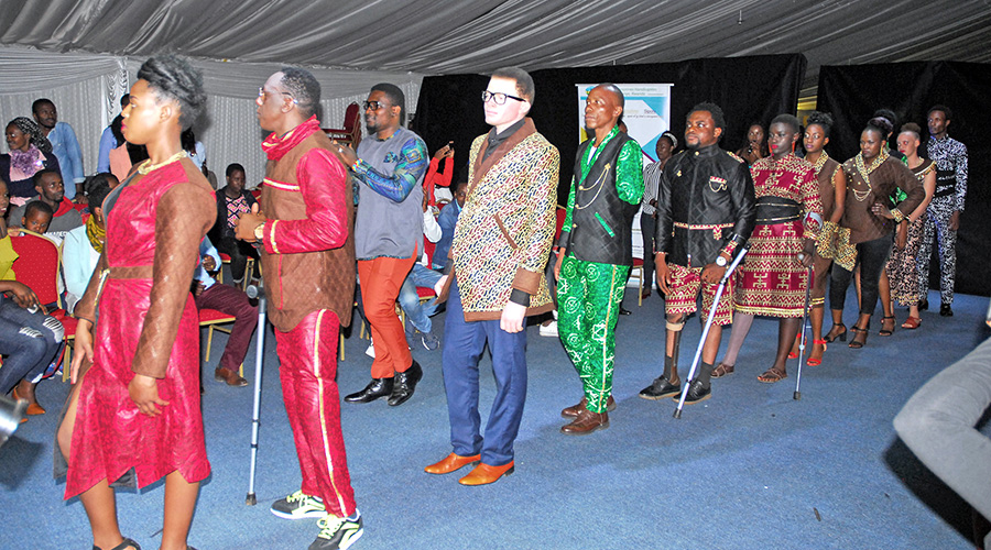 Female and male models with disabilities also walked the runway to rapturous applause from the audience. They showcased vibrant and fun prints by local and foreign fashion designers. / Photos by Dan Nsengiyumva