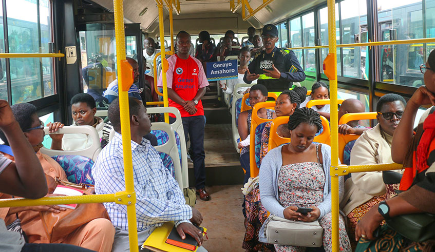 Passengers in bus listen to a police officer who spoke to them about the Gerayo Amahoro road safety campaign. Courtesy.