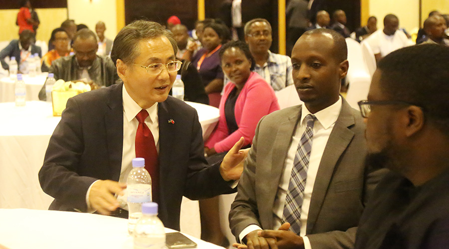 Chinese ambassador to Rwanda Rao Hongwei interacts with some of Rwandan officials who completed different trainings in China on Tuesday. 