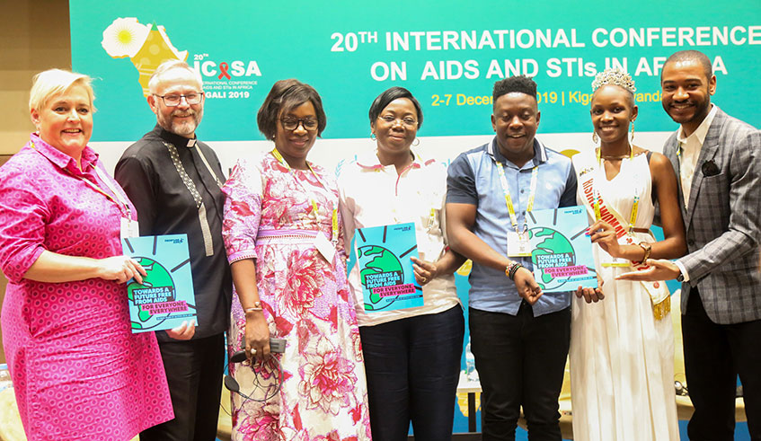 Panelists hold some booklets that highlight the global vision to end AIDS under the theme u2018Towards a future free from AIDS for everyone ,everywhereu2019. Photos: Dan Nsengiyumva.