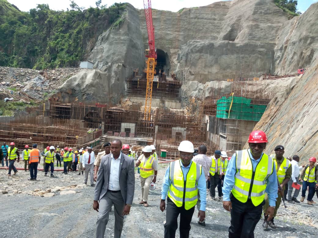 Rwanda's Infrastructure Minister Claver Gatete (R) and Tanzanian Energy Minister, Medard Kalemani (C), at the powerhouse being constructed. 