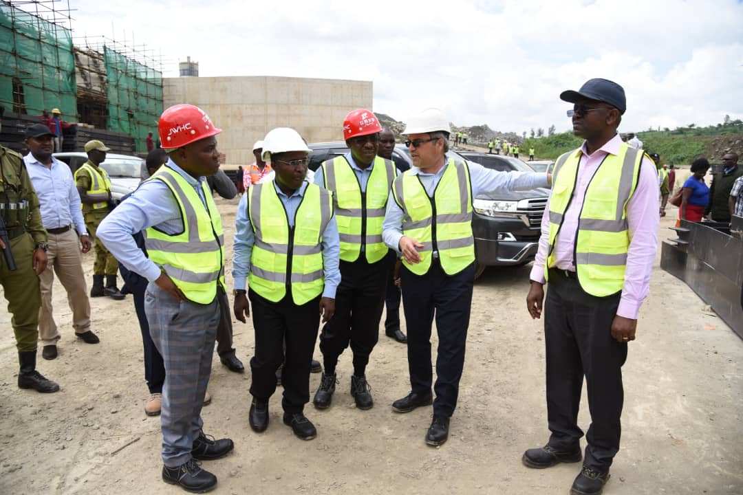 Rwanda's Infrastructure Minister Claver Gatete (R) and Tanzanian Energy Minister, Medard Kalemani (C), at the powerhouse being constructed. 