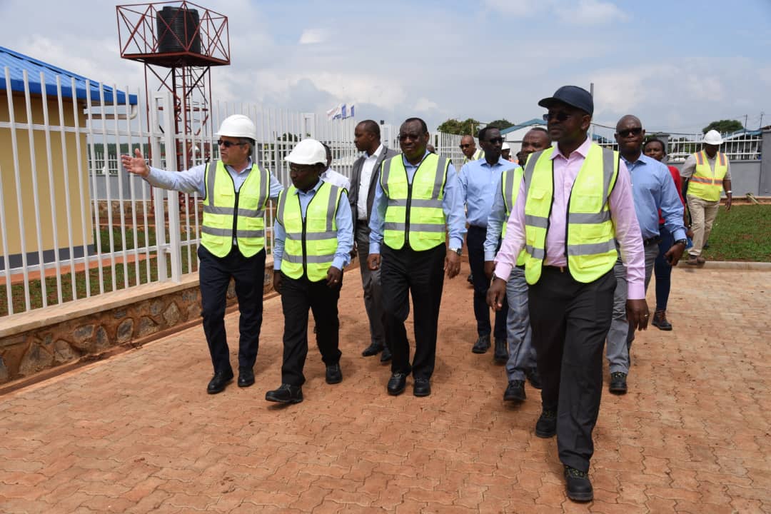 Rwanda's Infrastructure Minister Claver Gatete (R) and Tanzanian Energy Minister, Medard Kalemani (C), at the powerhouse being constructed. 