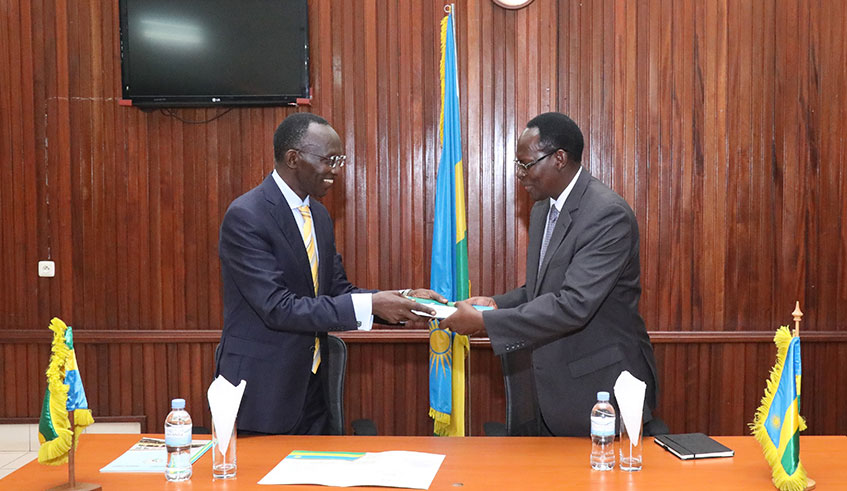 Former Chief Justice Prof Sam Rugege (left) hands over to the new Chief Justice Faustin Ntezilyayo in Kigali yesterday. Rugege, who has been at the helm of the judiciary for the past eight years, said he was leaving judiciary in good hands while Ntezilyayo vowed to build on the foundation laid by his predecessor, including in fighting corruption. Photo: Courtesy.