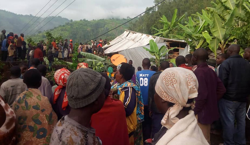 Residents of Muko Sector observe one of the house which was wiped out by last week landslides. Photo: Ru00e9gis Umurengezi.
