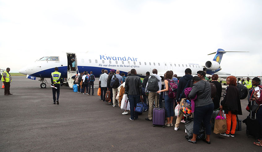 Passengers queue to board a RwandAir plane en route to Cape Town earlier this year. Rwanda has a visa-on-arrival policy not just for Africans, but also citizens of the whole world. Photo: Sam Ngendahimana.