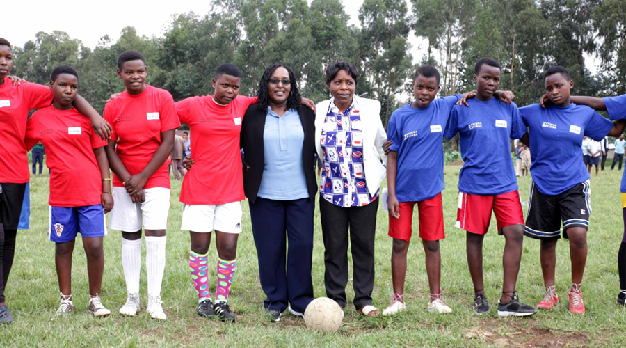 Fu00e9licitu00e9 Rwemalika (centre), the head of the Association of Kigali Women in Sports (AKWOS), poses with female football players. She says that women in sports would be less vulnerable if there are more women in sports leadership. 