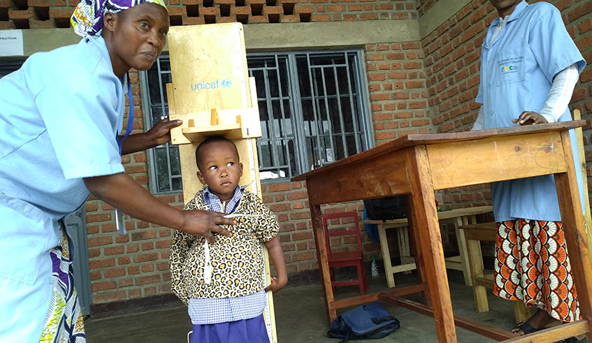 Community health workers check on a kid status at Rubavu cross border ECD centre. RÃ©gis Umurengezi 