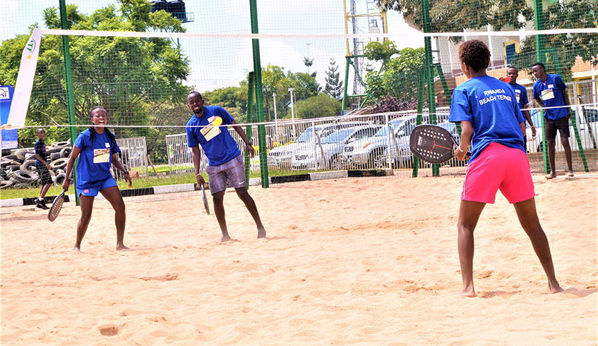 Players taste the feel of beach tennis for the first time after the sport was launched at Amahoro Stadium on Wednesday. Courtesy.