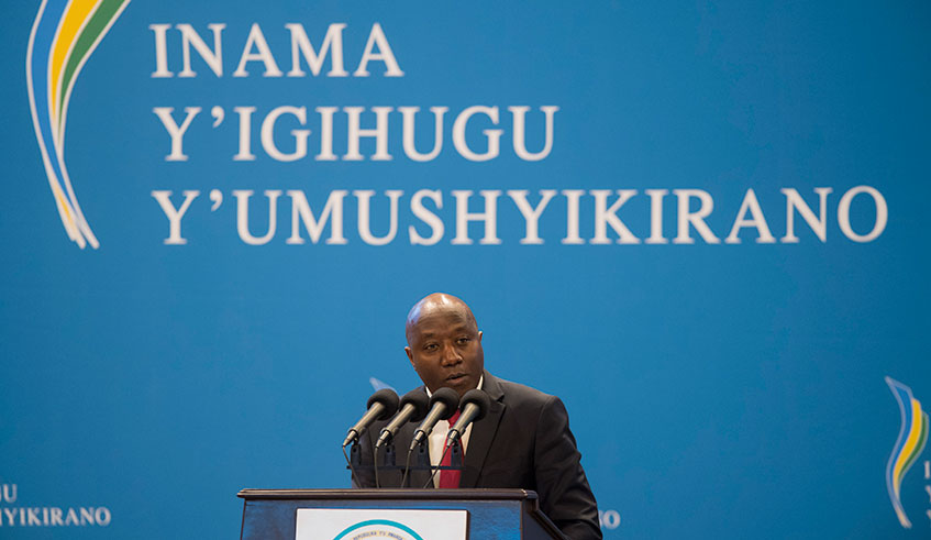 Prime Minister Edouard Ngirente presents a report on the implementation of the 2018 Umushyikirano resolutions on the first day of this yearu2019s edition at Kigali Convention Centre on Thursday. Photo: E. Kwizera.