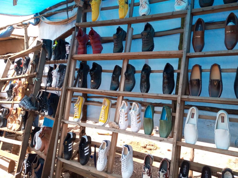 Shoes at Evariste Kamugisha's stand inside Kabarondo Market, Kayonza District. Shoe sellers said the business in festive season is yet to boom. 