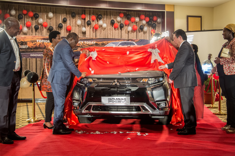 Ambassador Claver Gatete, Rwanda's minister of Infrastructure and chief guest at the launch event unveils the PHEV Outlander with the help of Mitsubishi Middle East and Africa President Mr. TakahashiÂ Masahiko during the Friday 20 December ceremony.