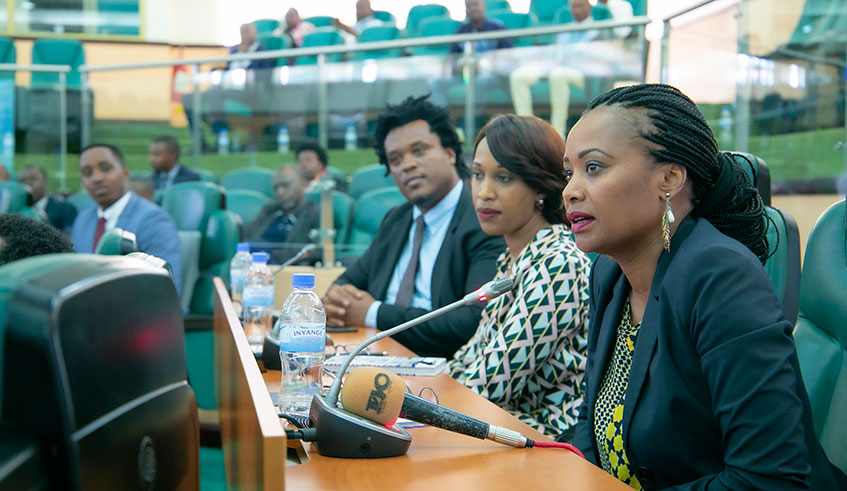 Rosine Mugunga, a member of the Rwandan community in Italy, contributes to a discussion on the fight against Genocide denial and minimisation between members of the Senate and Diaspora at the Parliamentary Buildings, while other delegates look on, in Kigali on Monday. Representatives of the Rwandan Diaspora from around the world urged the Senate to step up advocacy for enactment of laws against denial and trivialisation of the 1994 Genocide against the Tutsi in foreign countries. Photo: 