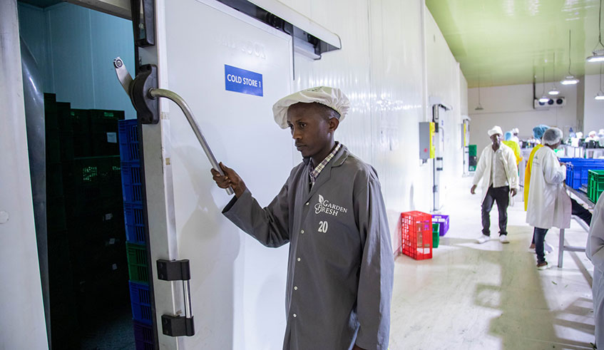 A man opens a cold room at NAEB export storage facility in Kigali. Photo: 