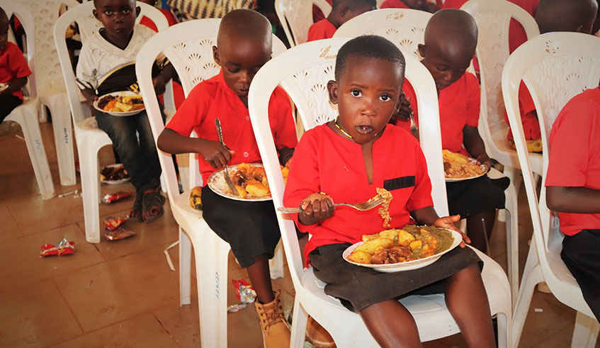Children in Huye District enjoy a meal during an event to celebrate Christmas organised by the NCC in partnership with FXB Rwanda.  Photo: 