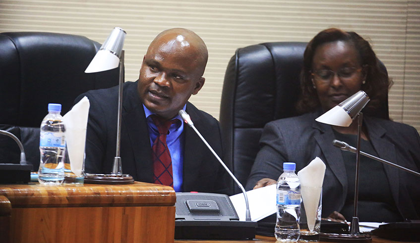 Prof. Omar Munyaneza (left), Chairperson of the Parliamentary Standing Committee on National Budget and Patrimony speaks during a session. 