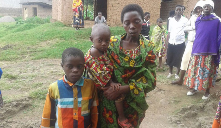 Beu0301atrice Mukamazera, the widow of the deceased, and two of their children. Photo: Courtesy.