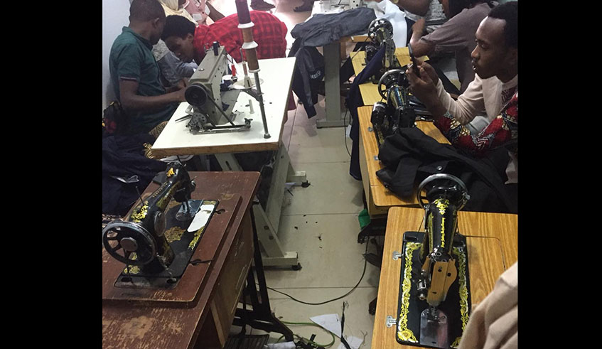 Some of Joyce Uwamahorou2019s employees work on clientsu2019 orders. 