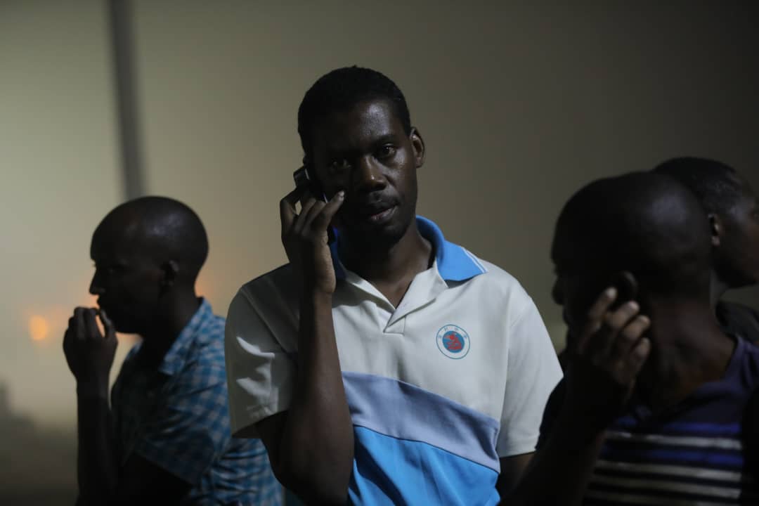 One of the released Rwandans makes a call to a relative at Gatuna border. (Emmanuel Kwizera)