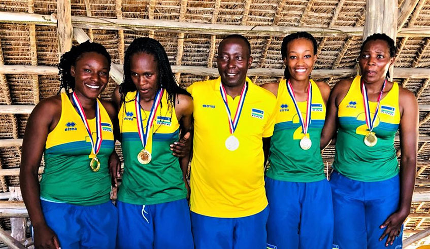 Head coach Christophe Mudahinyuka (C) and the two Rwandan teams pose for a group photo with medals after finishing top of sub-zone 5 qualifiers in Tanzania on Sunday. 