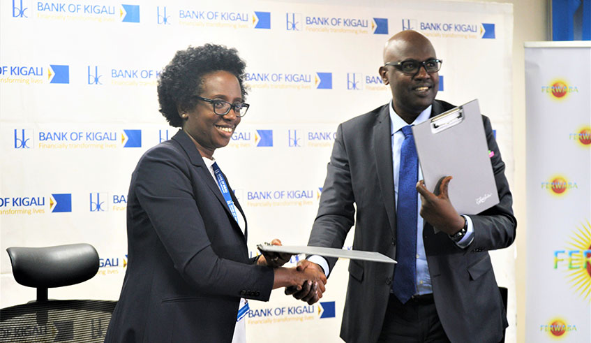 Du00e9siru00e9 Mugwiza (R), president of Rwanda Basketball Federation, and the Bank of Kigali Chief Executive Diane Karusisi after signing on Wednesday. 