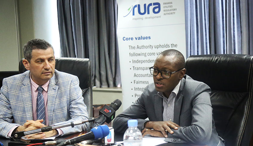 RURA Director General Patrick Nyirishema speaks to media as Rwanda Energy Group (REG) chief executive, Ron Weiss  looks on yesterday. 