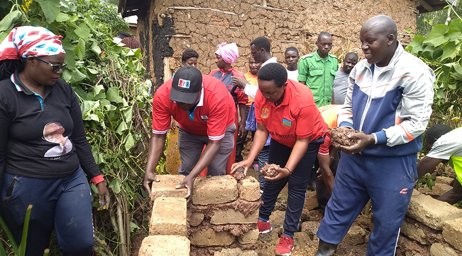 Members of Rwanda Patriotic Front (RPF-Inkotanyi) constructing a toilet for a vulnerable households in Cyanika Sector, Burera District. 