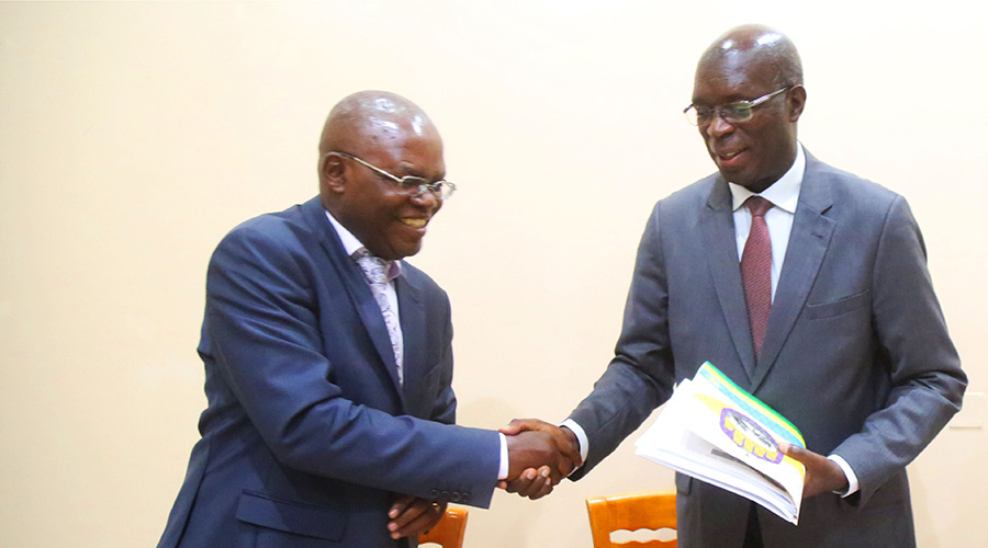 Appolinaire Mupiganyi, the Executive Secretary of Transparency International Rwanda (left), shakes hands with Ombudsman Anastase Murekezi during the presentation of the Corruption Perceptions Index (CPI) report in Kigali on Thursday. 